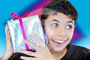 Boy excited holding a wrapped up christmas present