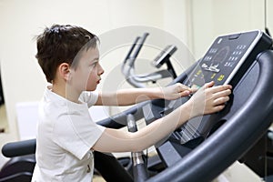 Boy exercising at stride treadmill