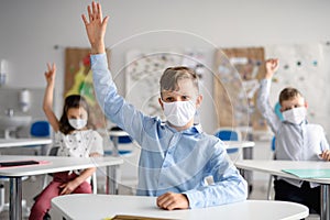 Boy with face mask back at school after covid-19 quarantine and lockdown.