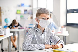 Boy with face mask back at school after covid-19 quarantine and lockdown.