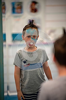 Boy with face painted like a shark