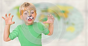 Boy with facepaint growling against blurry map