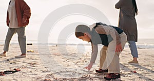 Boy, family and drawing in sand, beach and playful game for art, vacation and nature in sunshine. Male child, mother and