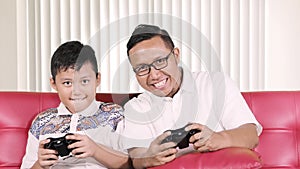 Boy and father playing video games