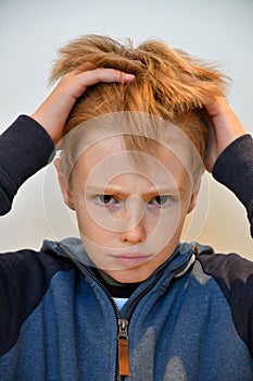 Boy feels misunderstood and pulls his hair photo