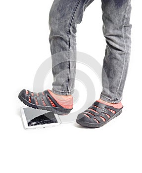 Boy feet step over on broken tablet on white background