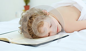 Boy fell asleep on the entries in the notebook. Healthy sleep concept