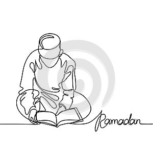 Boy in fez reading Koran