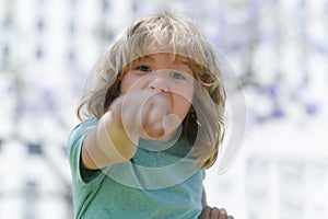 Boy fight with fist gesture punch. Child with angry expression. Angry hateful little crazy boy, child furious. Angry