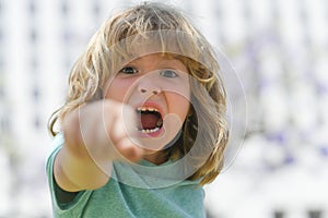 Boy fight with fist gesture punch. Kid boy with angry expression. Angry hateful little crazy boy, child furious. Angry