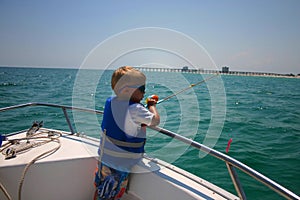Boy fishing on boat
