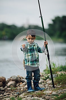 Boy fishing on the coast of river