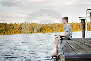 Boy Fishing on Dock at Lake