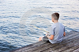 Boy Fishing on Dock at Lake