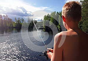 Boy fishing at a lake