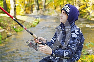 Boy fishing near river