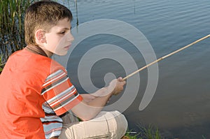 Boy fishing on the pond