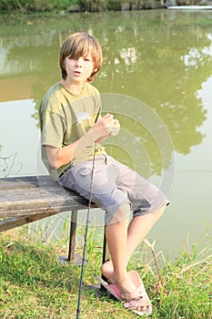 Boy fishing on pond