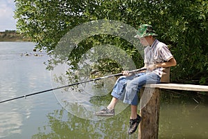 The boy with a fishing tackle