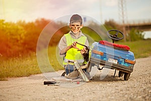 Boy fixes his retro toy car