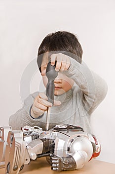 Boy fixing robot photo