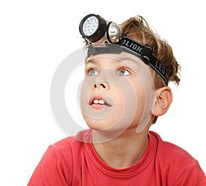 Boy with flashlight on his head on white