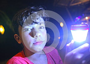 Boy with flashlight on night