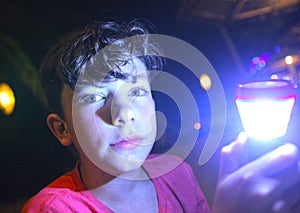Boy with flashlight on night photo