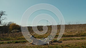 The boy flies over the wheel of a runbike, hard fall