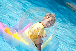 Boy on float swimming pool