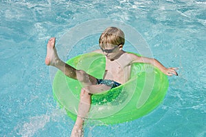 Boy On Float Tube In Swimming Pool