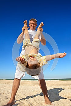 Boy flying on his parent's hands