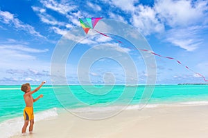Boy flying kite on beach photo