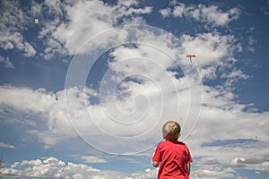 Boy Flying Kite With Cloudy Sky