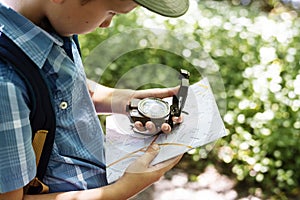 Boy following the directions of a compass