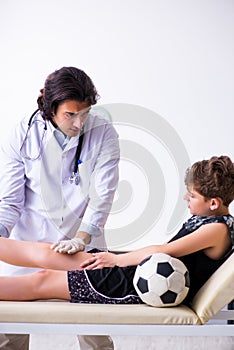 Boy football player visiting young doctor traumatologist