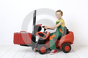 A boy in a forklift.