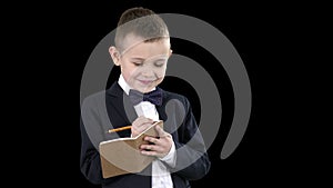 Boy in a formal clothes writing in check list or notebook, alpha channel