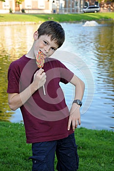 Boy with freckles enjoys  lolly