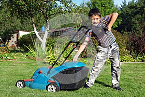 Boy Gardener mowing the lawn