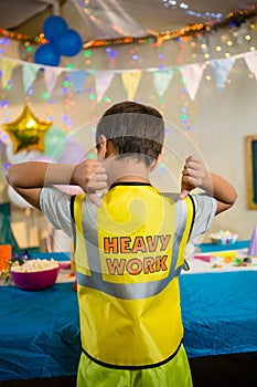 Boy gesturing to the text on protective workwear