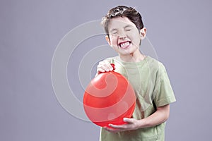 Boy gets air blast from balloon.