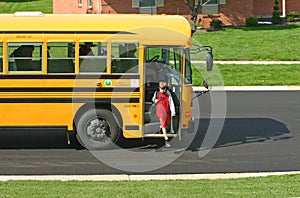 Boy Getting off School Bus