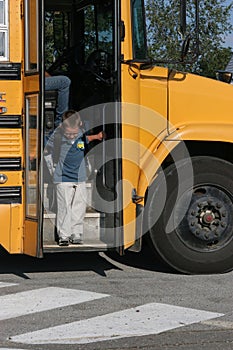 Boy getting off the school bus
