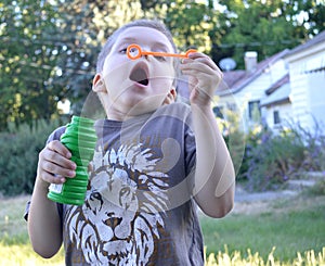 Boy getting ready to blow a big bubble! photo