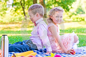 Boy and a girl of 6 years on a picnic