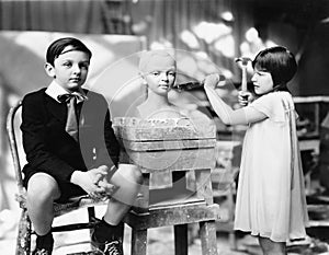 Boy and girl in an artist studio