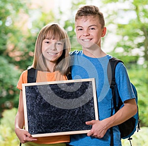 Boy and girl with blackboard