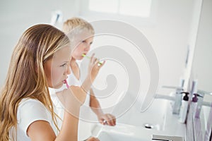 Boy and girl brushing teeth