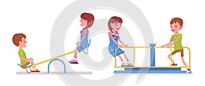 Boy and girl child 7 to 9 years old on seesaw, carousel